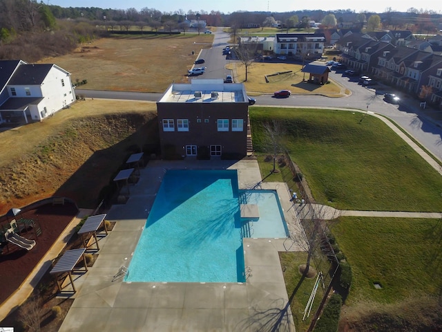 community pool featuring a residential view and a patio