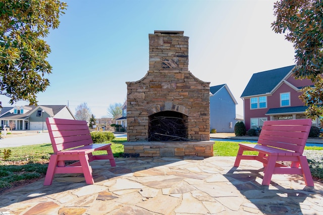 view of patio with an outdoor stone fireplace