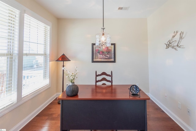 office space featuring dark wood-style floors, visible vents, and baseboards