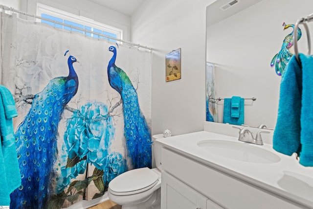 bathroom with visible vents, toilet, vanity, and a shower with curtain