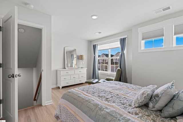 bedroom featuring visible vents, recessed lighting, light wood-type flooring, and baseboards