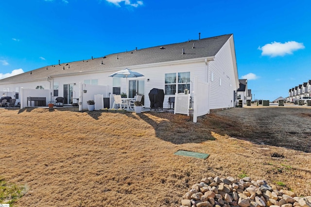 back of house featuring a patio area and fence