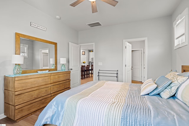 bedroom with visible vents, ceiling fan, and light wood-style floors