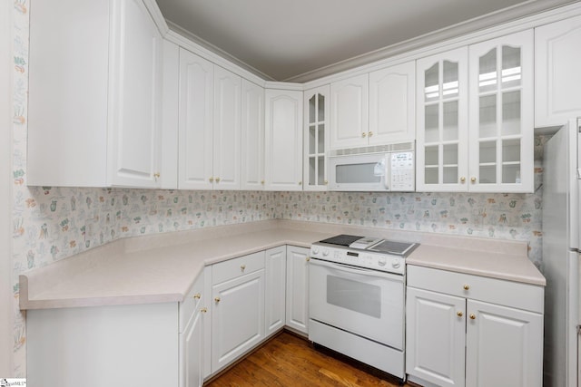 kitchen with glass insert cabinets, white appliances, white cabinetry, and wallpapered walls