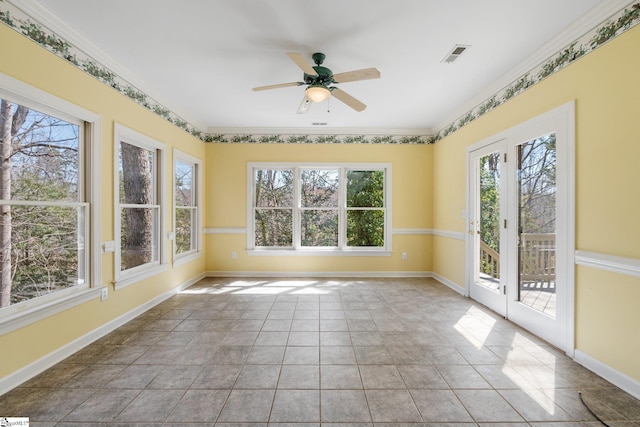 unfurnished sunroom with visible vents and ceiling fan