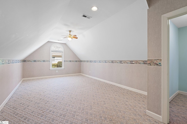 bonus room with vaulted ceiling, a ceiling fan, visible vents, and carpet floors