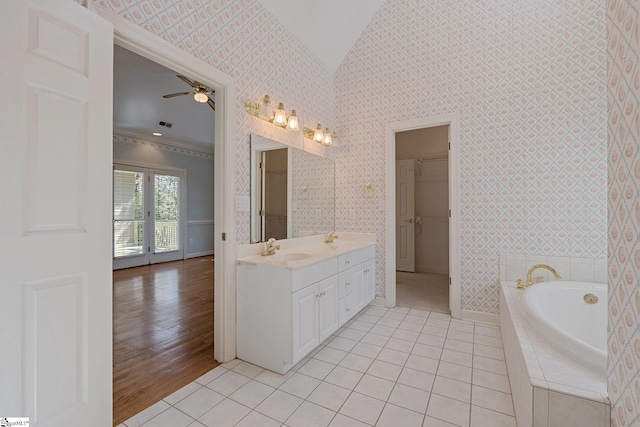 full bathroom featuring tile patterned flooring, a spacious closet, wallpapered walls, ceiling fan, and a garden tub