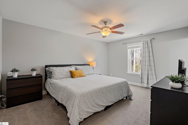 bedroom featuring visible vents, baseboards, carpet, and ceiling fan