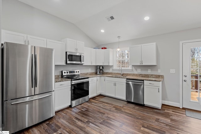 kitchen with visible vents, appliances with stainless steel finishes, dark wood-style floors, white cabinets, and a sink