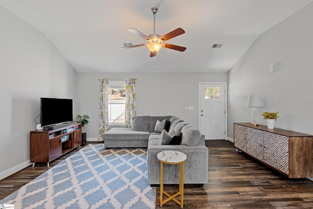 living area with visible vents, dark wood-type flooring, a ceiling fan, baseboards, and lofted ceiling