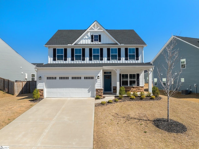 view of front of house with board and batten siding, concrete driveway, covered porch, stone siding, and an attached garage