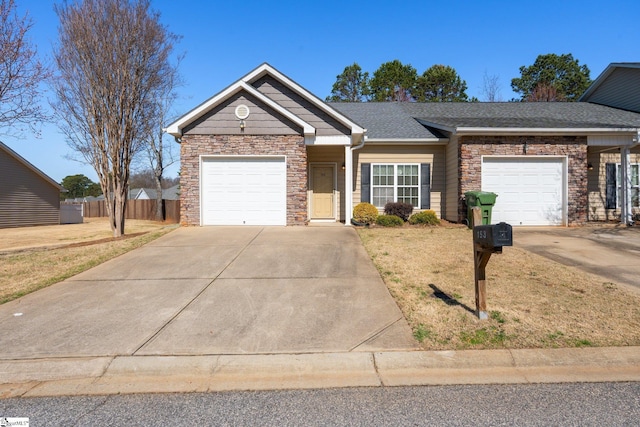 single story home featuring stone siding, driveway, and a garage