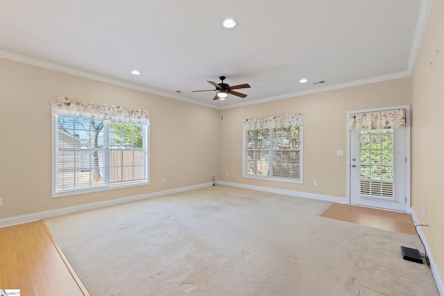 carpeted empty room with visible vents, baseboards, ornamental molding, recessed lighting, and a ceiling fan