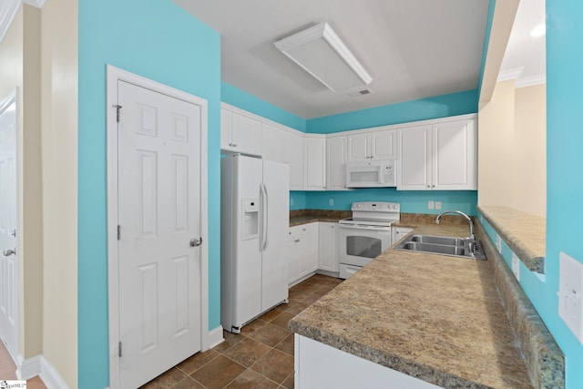 kitchen with visible vents, a sink, white cabinetry, white appliances, and baseboards