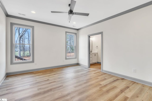 unfurnished bedroom with light wood-style flooring, multiple windows, baseboards, and visible vents