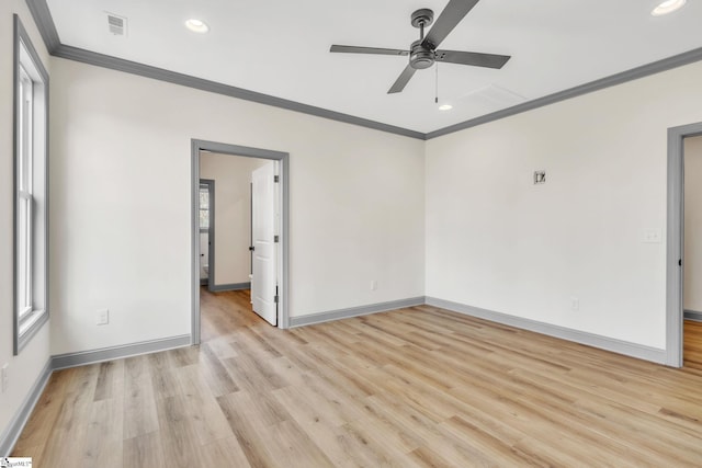 empty room featuring light wood-style flooring, baseboards, ceiling fan, and ornamental molding