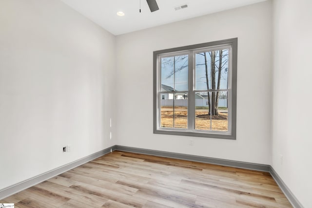 unfurnished room with visible vents, baseboards, light wood-style floors, and ceiling fan