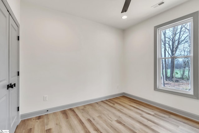 spare room featuring a ceiling fan, visible vents, baseboards, light wood-style flooring, and recessed lighting