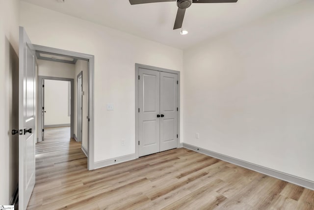 unfurnished bedroom featuring light wood-style flooring, recessed lighting, a closet, baseboards, and ceiling fan