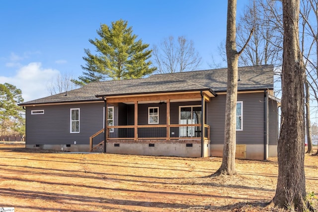 rear view of house with a shingled roof, covered porch, and crawl space