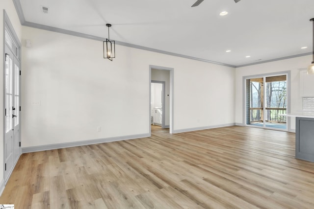 interior space with visible vents, light wood-style floors, crown molding, and a ceiling fan