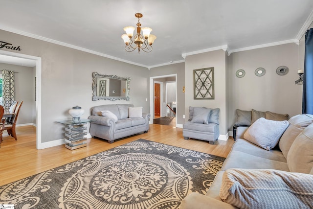 living area featuring baseboards, wood finished floors, an inviting chandelier, and ornamental molding