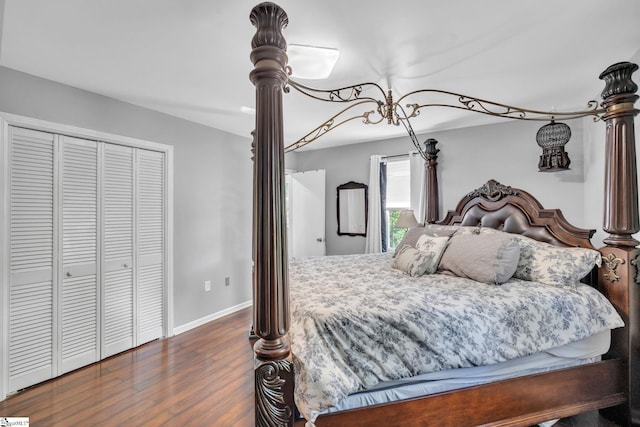 bedroom with a closet, baseboards, and wood finished floors