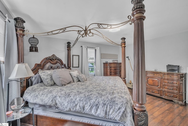 bedroom with dark wood-type flooring