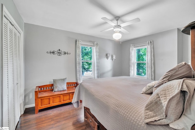 bedroom featuring ceiling fan, a closet, baseboards, and wood finished floors