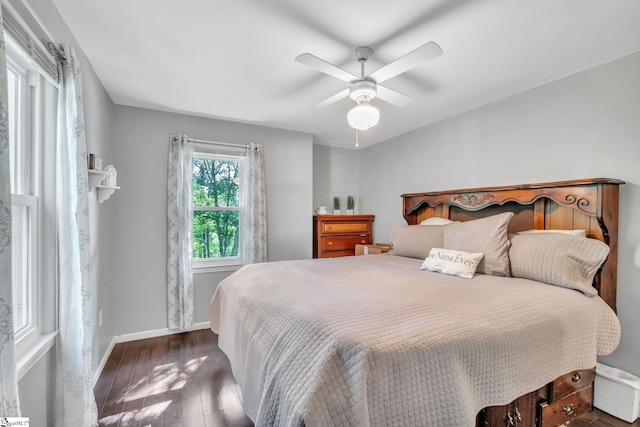 bedroom with a ceiling fan, baseboards, and wood finished floors