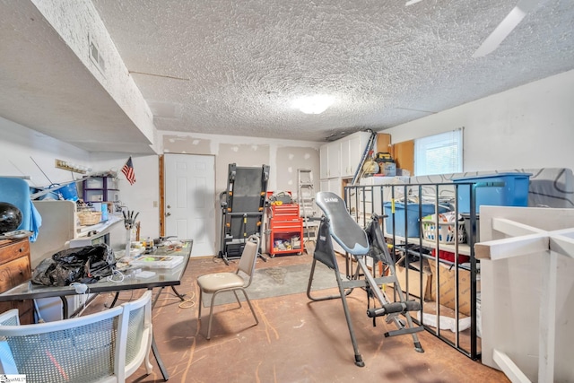 basement with visible vents and a textured ceiling