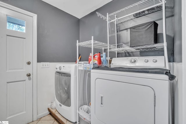 washroom with light tile patterned floors, independent washer and dryer, and laundry area