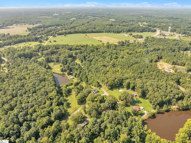 bird's eye view with a forest view and a water view