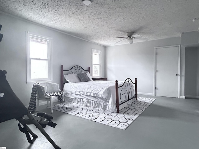 bedroom with ceiling fan, a textured ceiling, and finished concrete floors