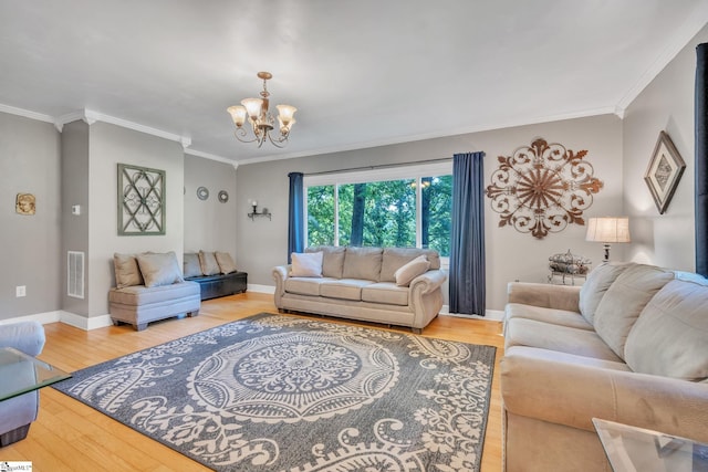 living room featuring visible vents, baseboards, an inviting chandelier, and wood finished floors