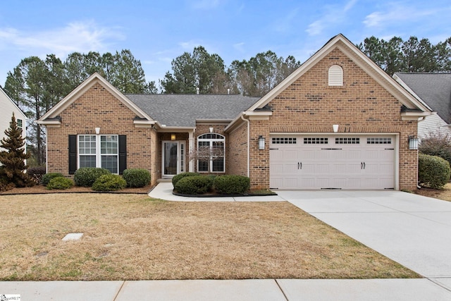 view of front of property with brick siding, a shingled roof, a front lawn, a garage, and driveway