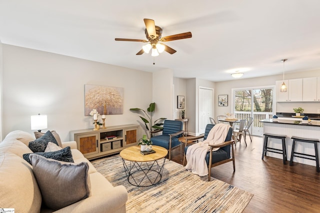 living room with wood finished floors and a ceiling fan