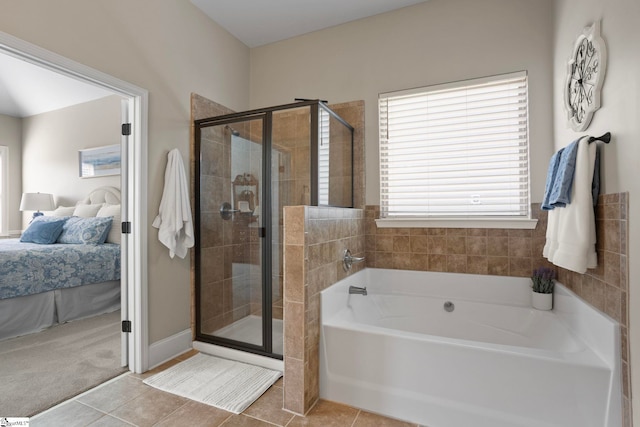 ensuite bathroom featuring tile patterned floors, a stall shower, ensuite bath, and a bath