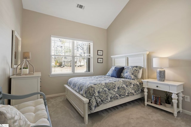 bedroom featuring vaulted ceiling, light colored carpet, baseboards, and visible vents