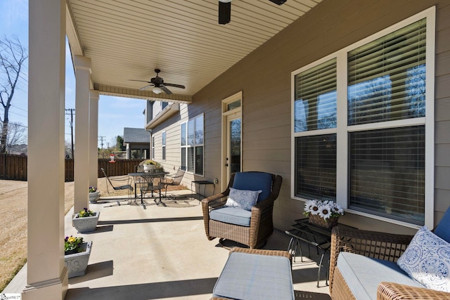 view of patio / terrace featuring outdoor dining area, fence, and ceiling fan