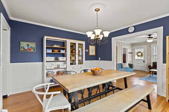 dining room featuring light wood-style floors and a wainscoted wall