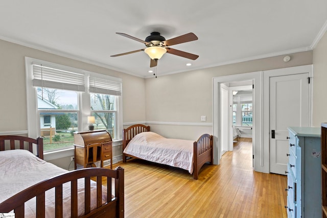 bedroom with recessed lighting, multiple windows, crown molding, and light wood-type flooring