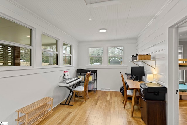 home office featuring attic access, hardwood / wood-style flooring, visible vents, and ornamental molding