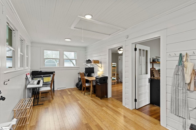 home office featuring visible vents, attic access, ceiling fan, wood-type flooring, and wooden ceiling