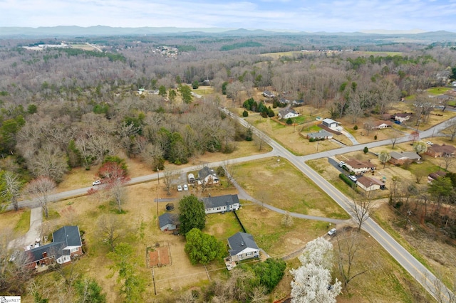 drone / aerial view with a view of trees and a mountain view