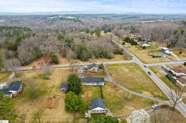 birds eye view of property featuring a mountain view and a forest view