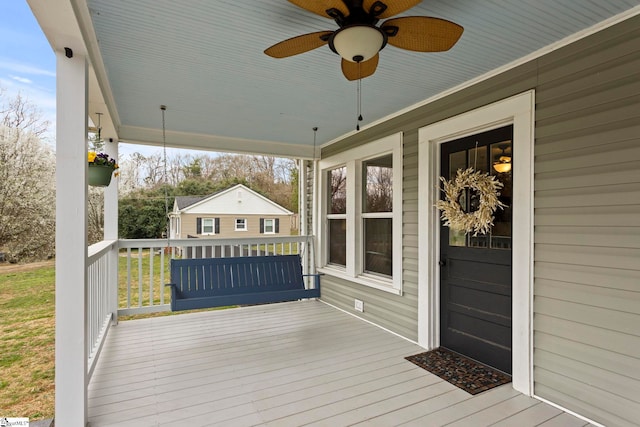 wooden terrace featuring a ceiling fan