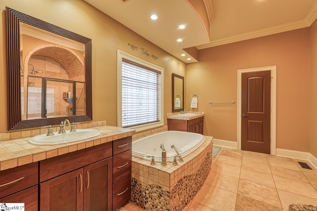 bathroom featuring visible vents, a stall shower, a tub with jets, and a sink