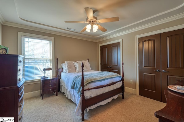 bedroom with a ceiling fan, baseboards, visible vents, ornamental molding, and light carpet