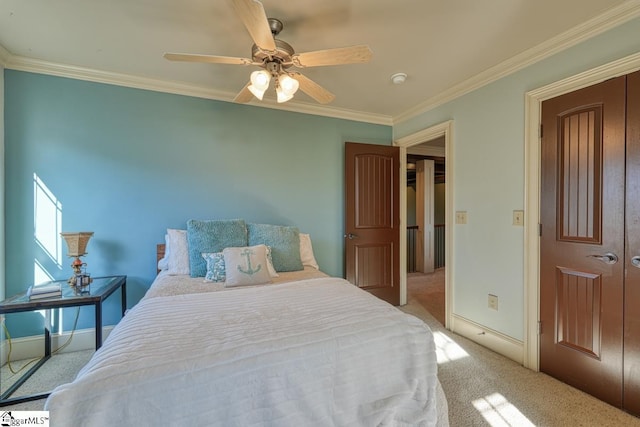 carpeted bedroom with baseboards, ceiling fan, and crown molding